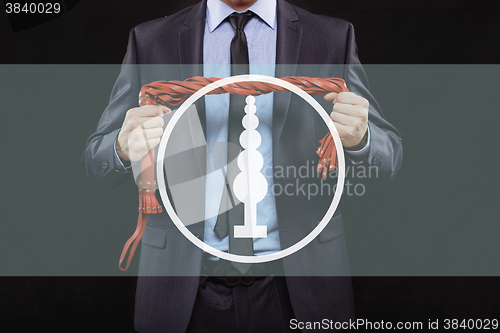 Image of man in business suit with chained hands. handcuffs for sex games. concept of erotic entertainment.