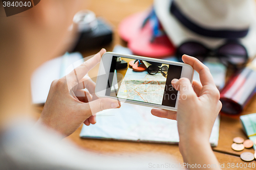 Image of close up of woman with smartphone and travel stuff