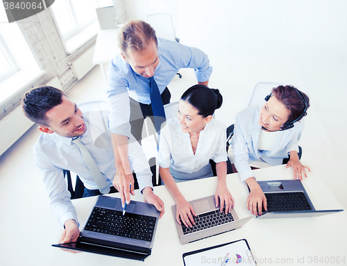 Image of group of people working in call center