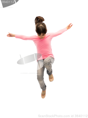 Image of happy little girl jumping in air