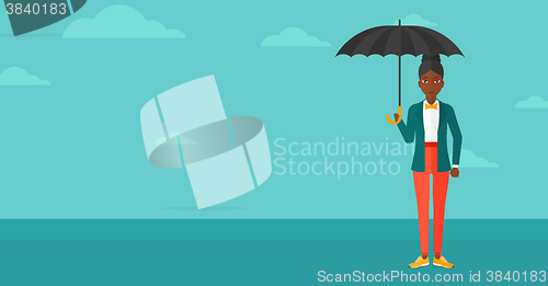 Image of Business woman standing with umbrella.