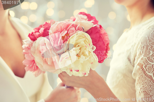 Image of close up of happy lesbian couple with flowers