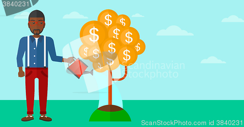 Image of Man watering money tree.