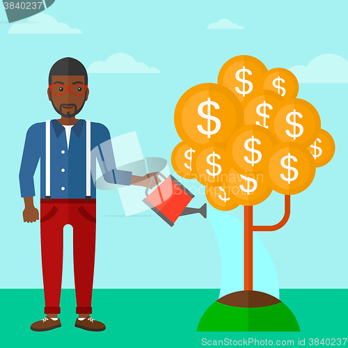 Image of Man watering money tree.