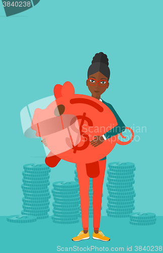 Image of Woman carrying piggy bank.