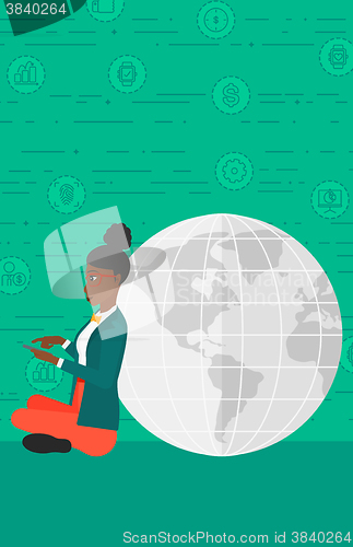 Image of Woman sitting near globe.