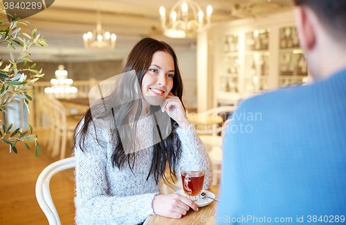 Image of happy couple drinking tea at cafe