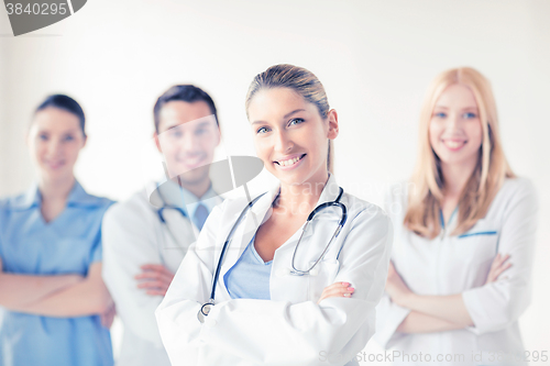 Image of female doctor in front of medical group