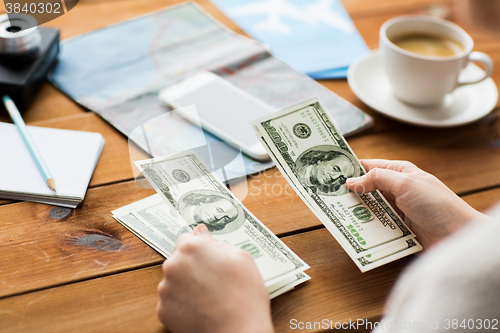 Image of close up of traveler hands counting dollar money