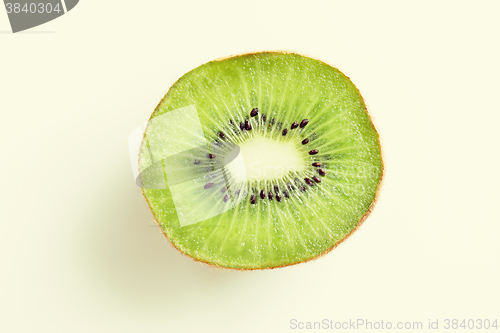 Image of close up of ripe kiwi slice on table