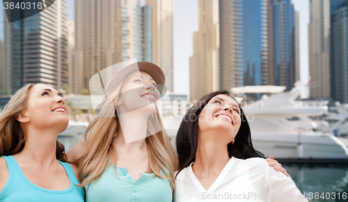 Image of young women over dubai city harbour and boats