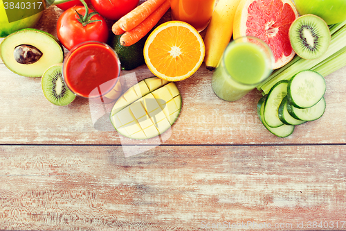 Image of close up of fresh juice glass and fruits on table