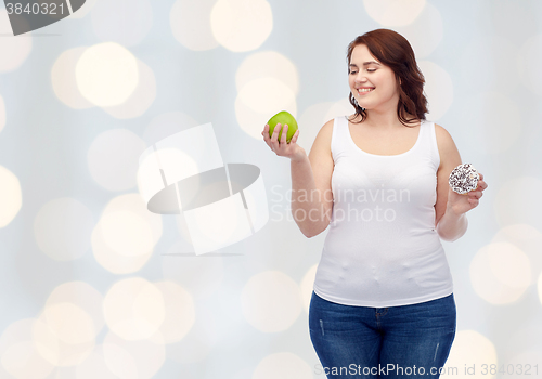 Image of happy plus size woman choosing apple or donut