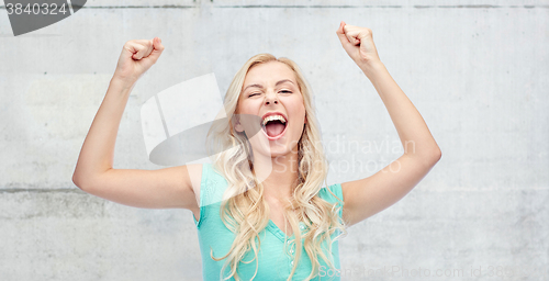 Image of happy young woman or teen girl celebrating victory