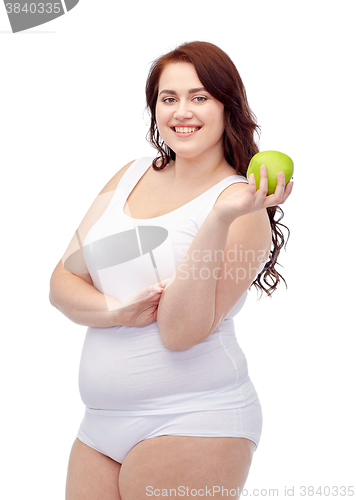 Image of happy plus size woman in underwear with apple