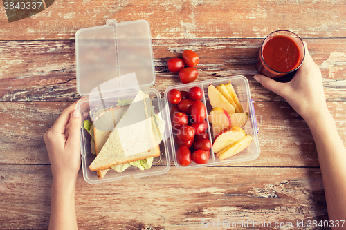 Image of close up of woman with food in plastic container