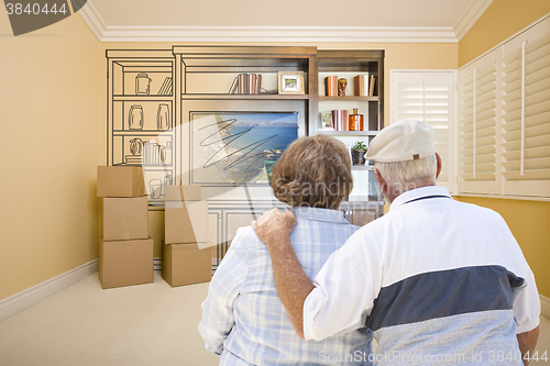 Image of Senior Couple Looking At Drawing of Entertainment Unit In Room
