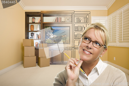 Image of Female Holding Pencil In Room With Drawing of Entertainment Unit