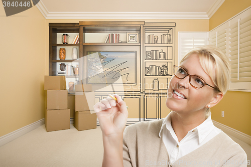 Image of Female Holding Pencil In Room With Drawing of Entertainment Unit