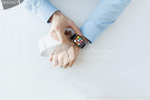 Image of hands with application icons on smart watch