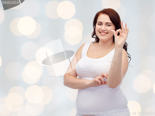 Image of plus size woman in underwear showing ok hand sign