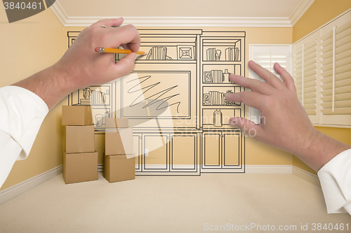 Image of Hands Drawing Entertainment Unit In Room With Moving Boxes