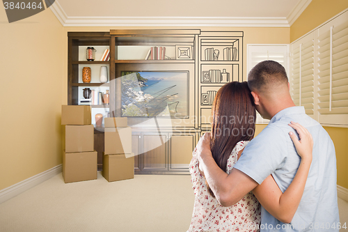 Image of Young Couple Looking At Drawing of Entertainment Unit In Room