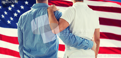 Image of close up of happy male gay couple hugging