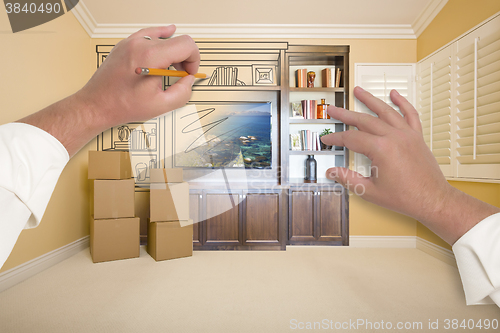 Image of Hands Drawing Entertainment Unit In Room With Moving Boxes