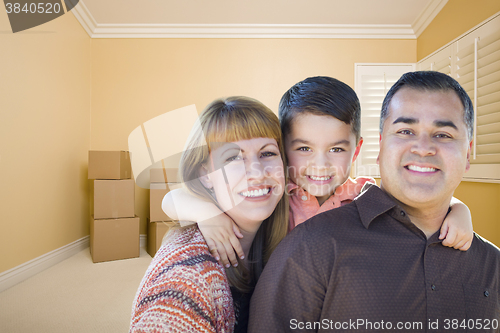 Image of Young Mixed Race Family In Room With Moving Boxes