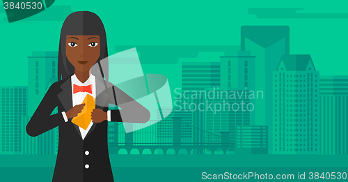 Image of Woman putting envelope in pocket.