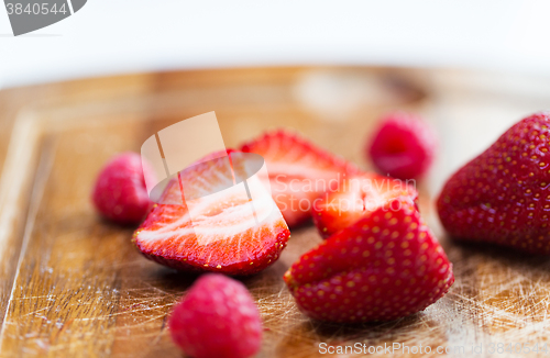 Image of close up of ripe red strawberries on cutting board