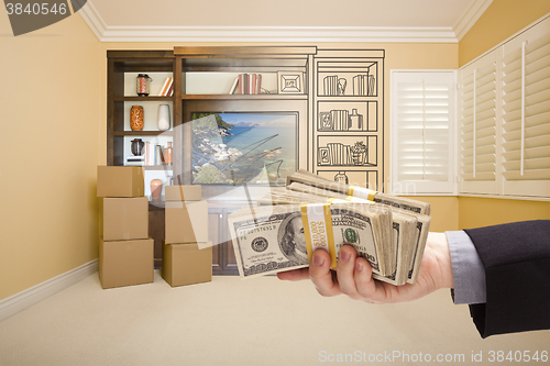 Image of Holding Out Cash Over Drawing of Entertainment Unit In Room