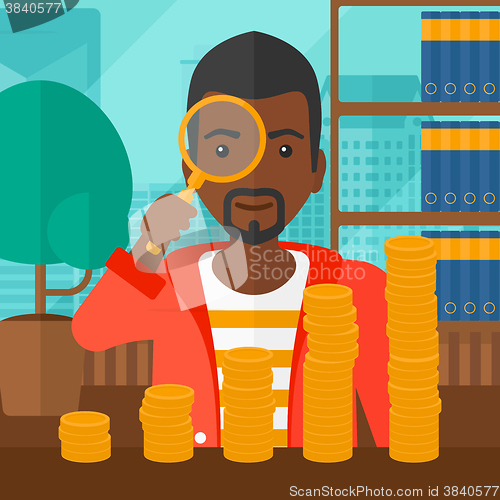 Image of Man with magnifier and golden coins. 
