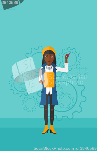 Image of Woman standing on gears background.