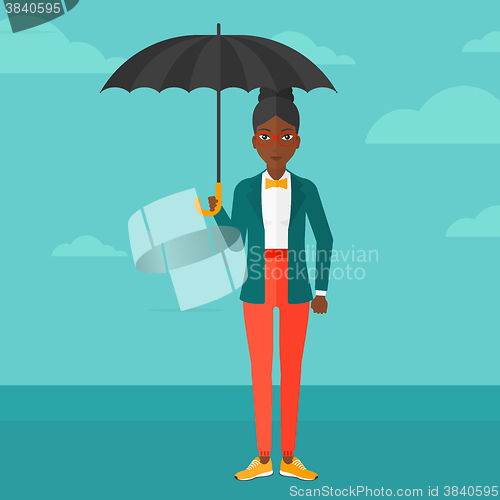 Image of Business woman standing with umbrella.