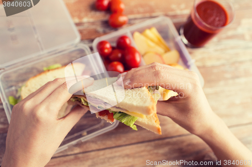 Image of close up of woman with food in plastic container