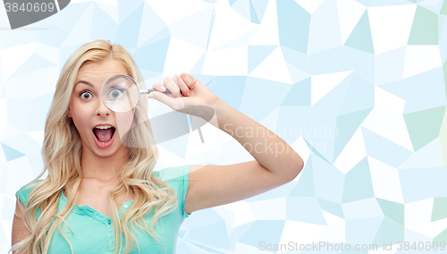 Image of happy young woman with magnifying glass