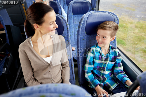 Image of happy family riding in travel bus