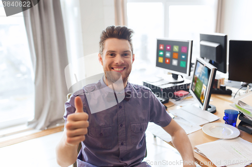 Image of happy male office worker showing thumbs up