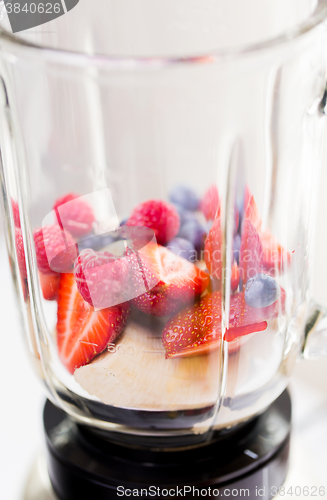 Image of close up of blender shaker with fruits and berries