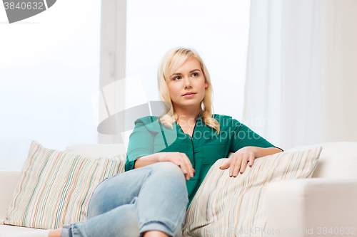 Image of happy young woman at home