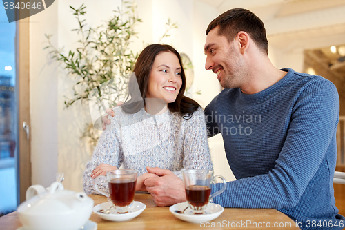 Image of happy couple drinking tea at restaurant