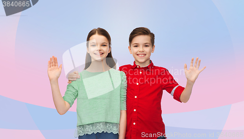 Image of happy boy and girl waving hand