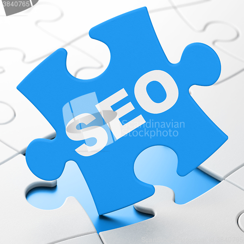 Image of Web development concept: SEO on puzzle background