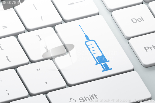 Image of Health concept: Syringe on computer keyboard background