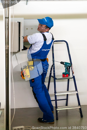 Image of Young electrician performs task of competition