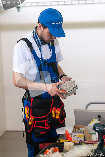 Image of Young electrician performs task of competition