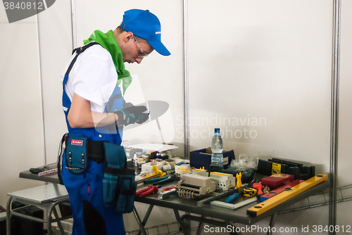 Image of Young electrician performs task of competition