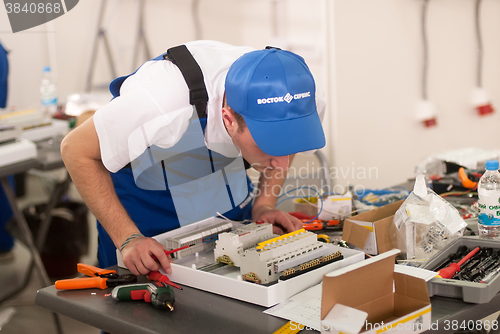 Image of Young electrician performs task of competition